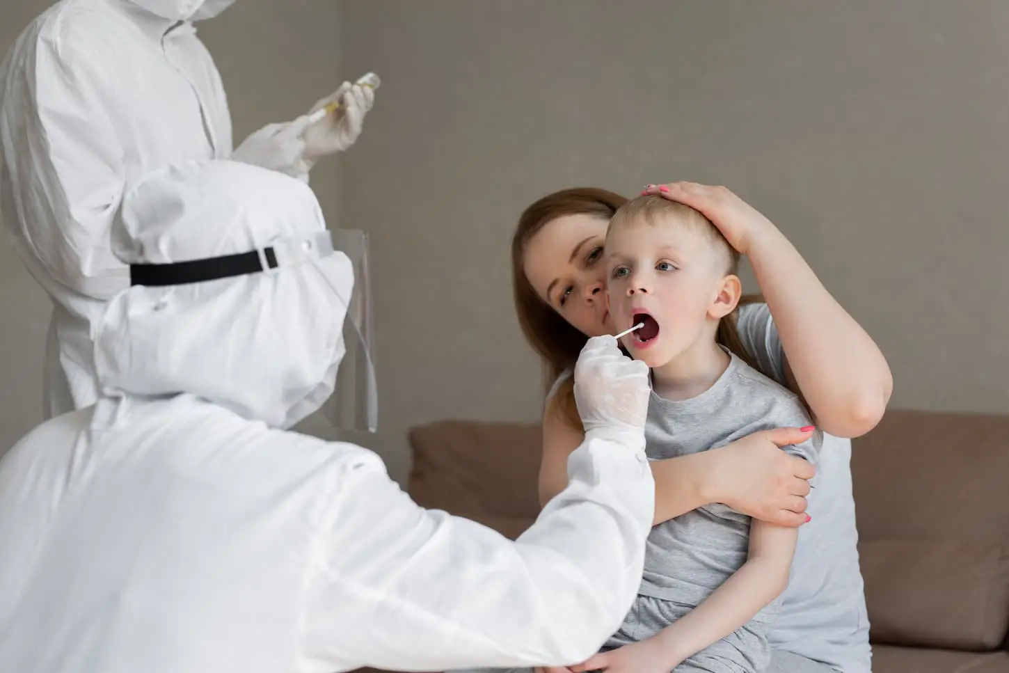 An image of doctor takes a cotton bud from child s mouth to analyze the saliva, mucous membrane for DNA tests.