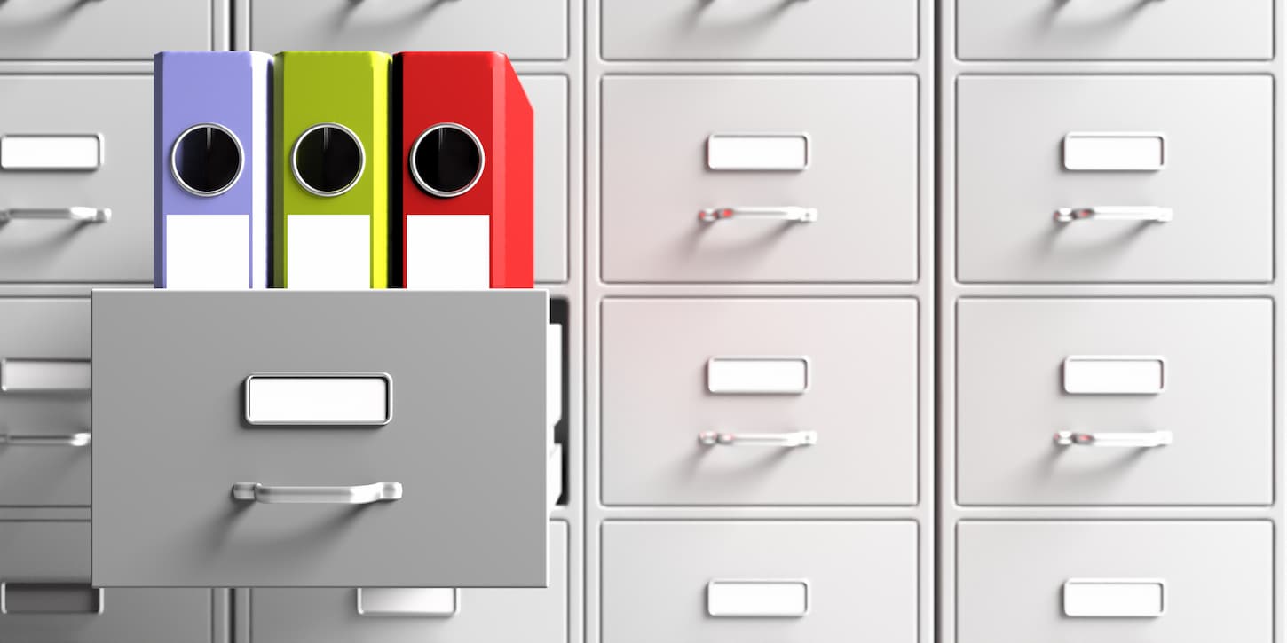 An image of office file folders in an open cabinet drawer closeup view. Document data archive storage, Business administration concept.