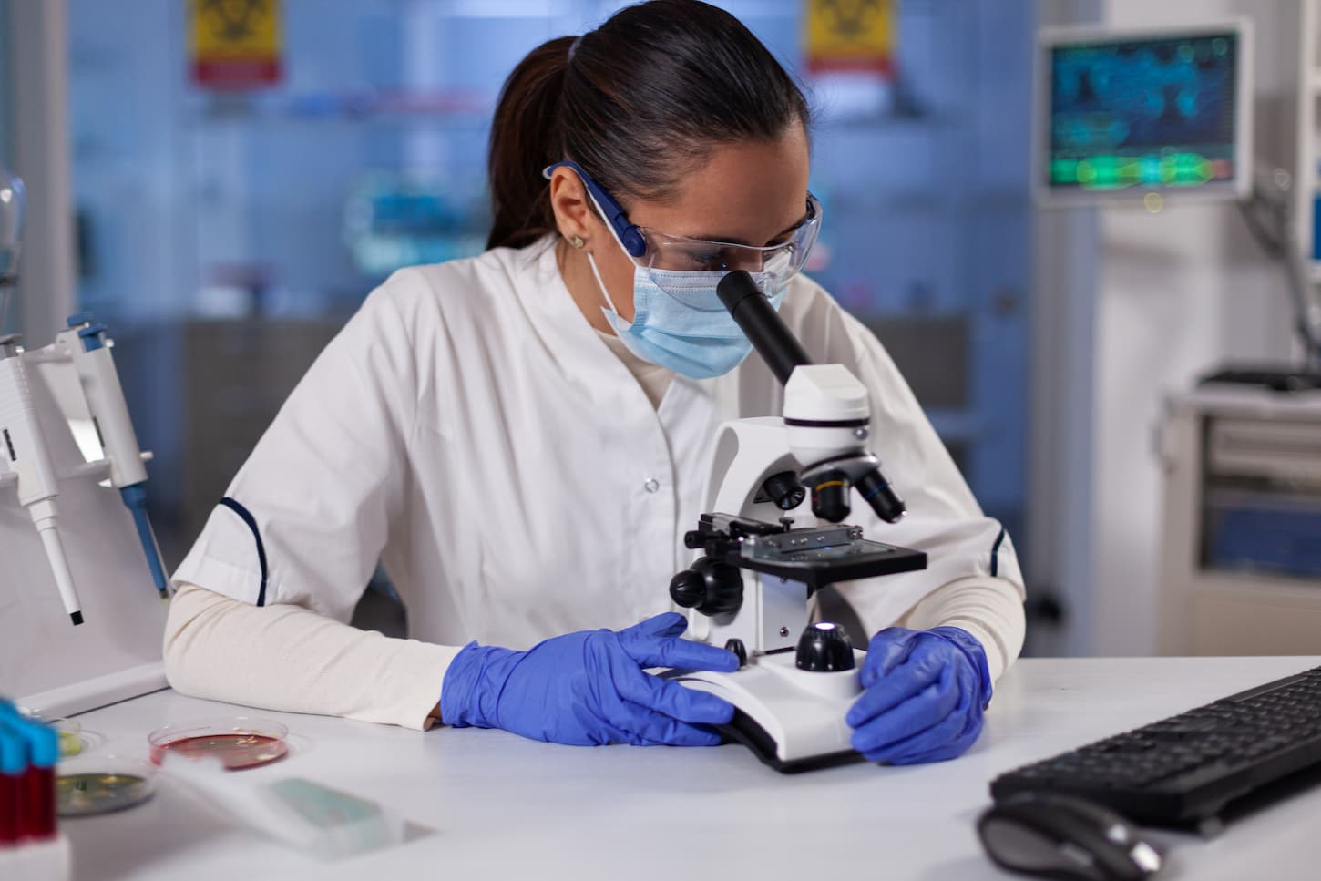 An image of a Specialist researcher analyzing genetic sample using medical microscope.