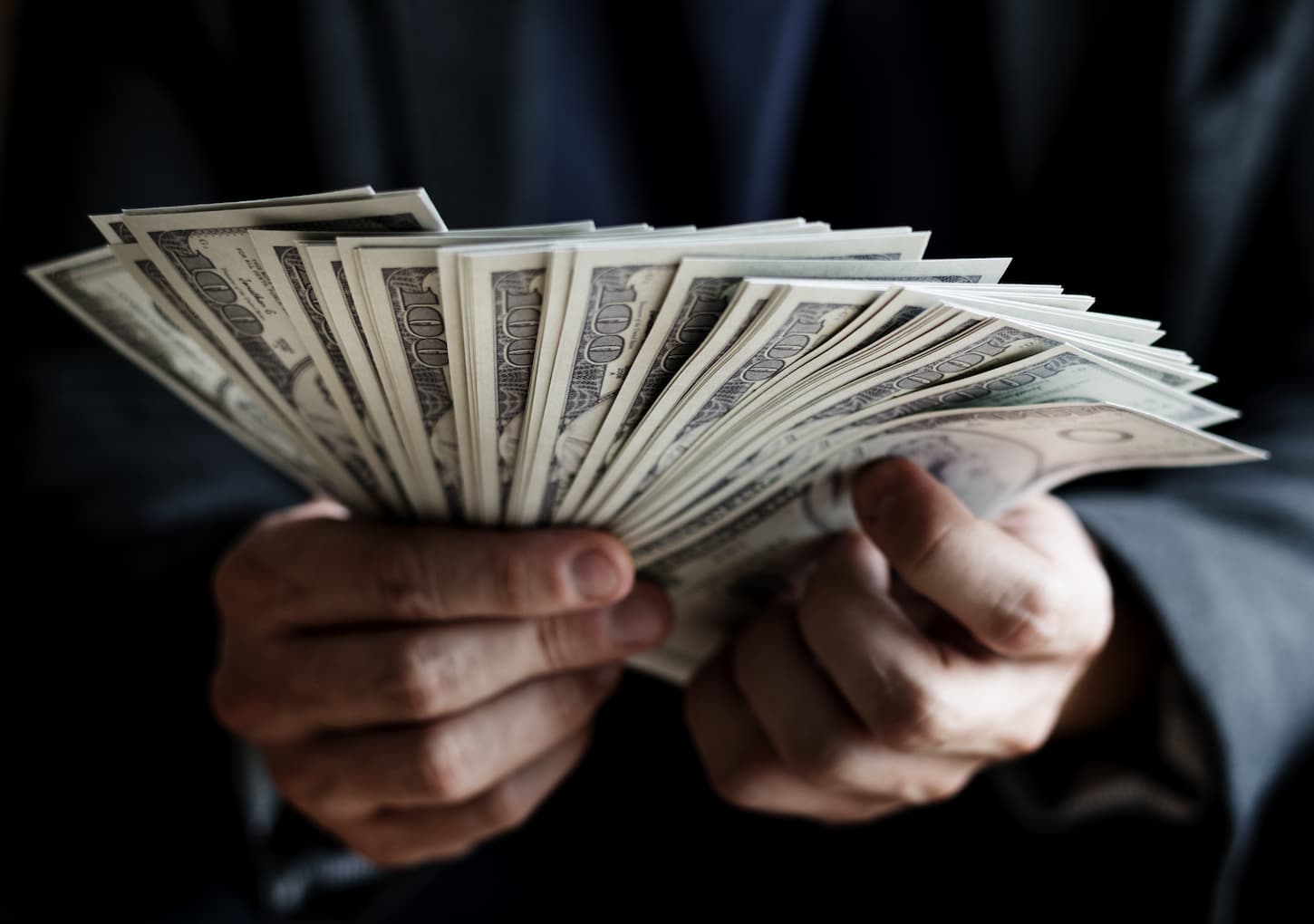 An image of hands holding cash.